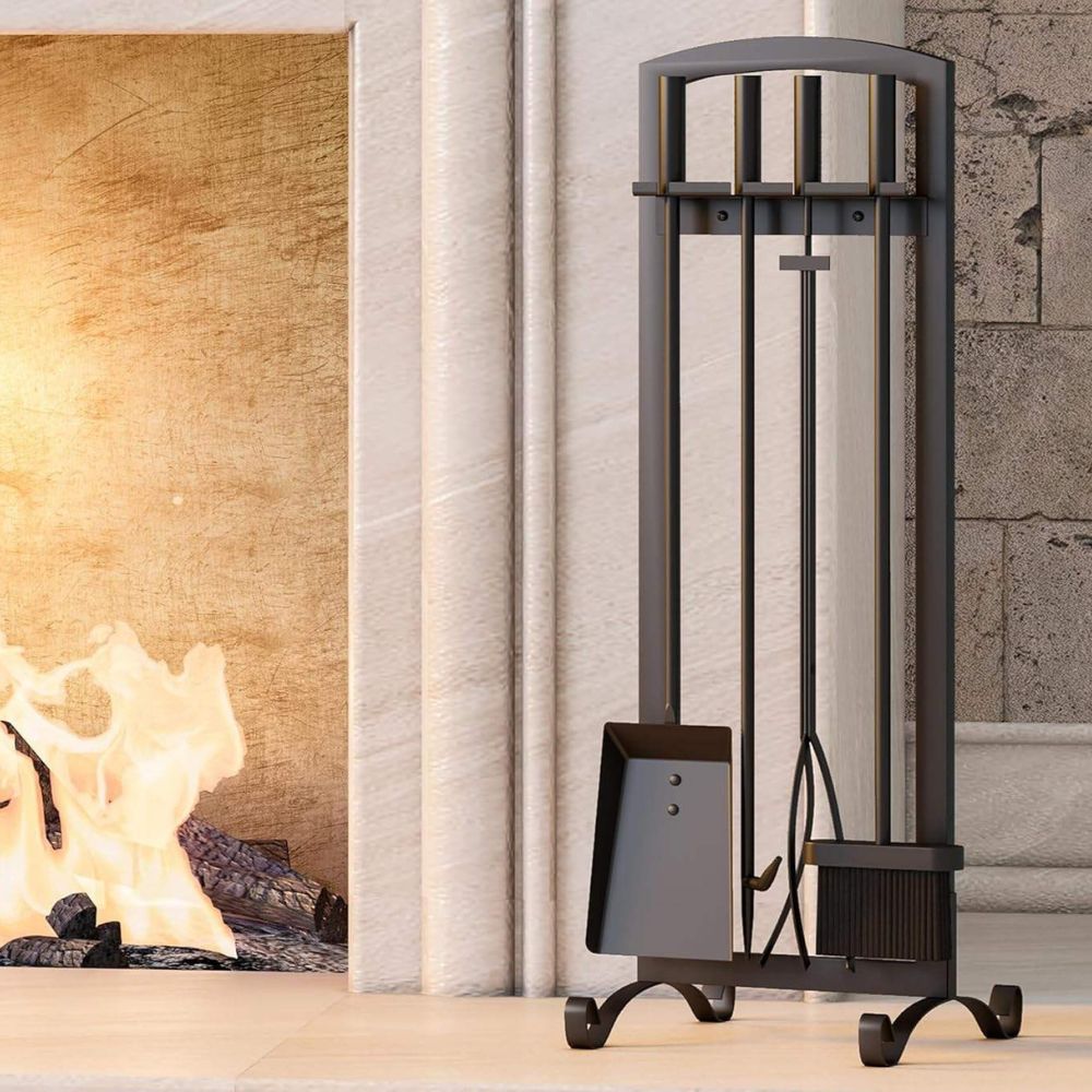 Black metal fireplace tool set in front of a lit fireplace.