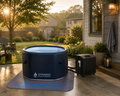 Dynamic Cold Therapy inflatable cold plunge system with WiFi chiller installed on a backyard patio during golden hour at a suburban home.
