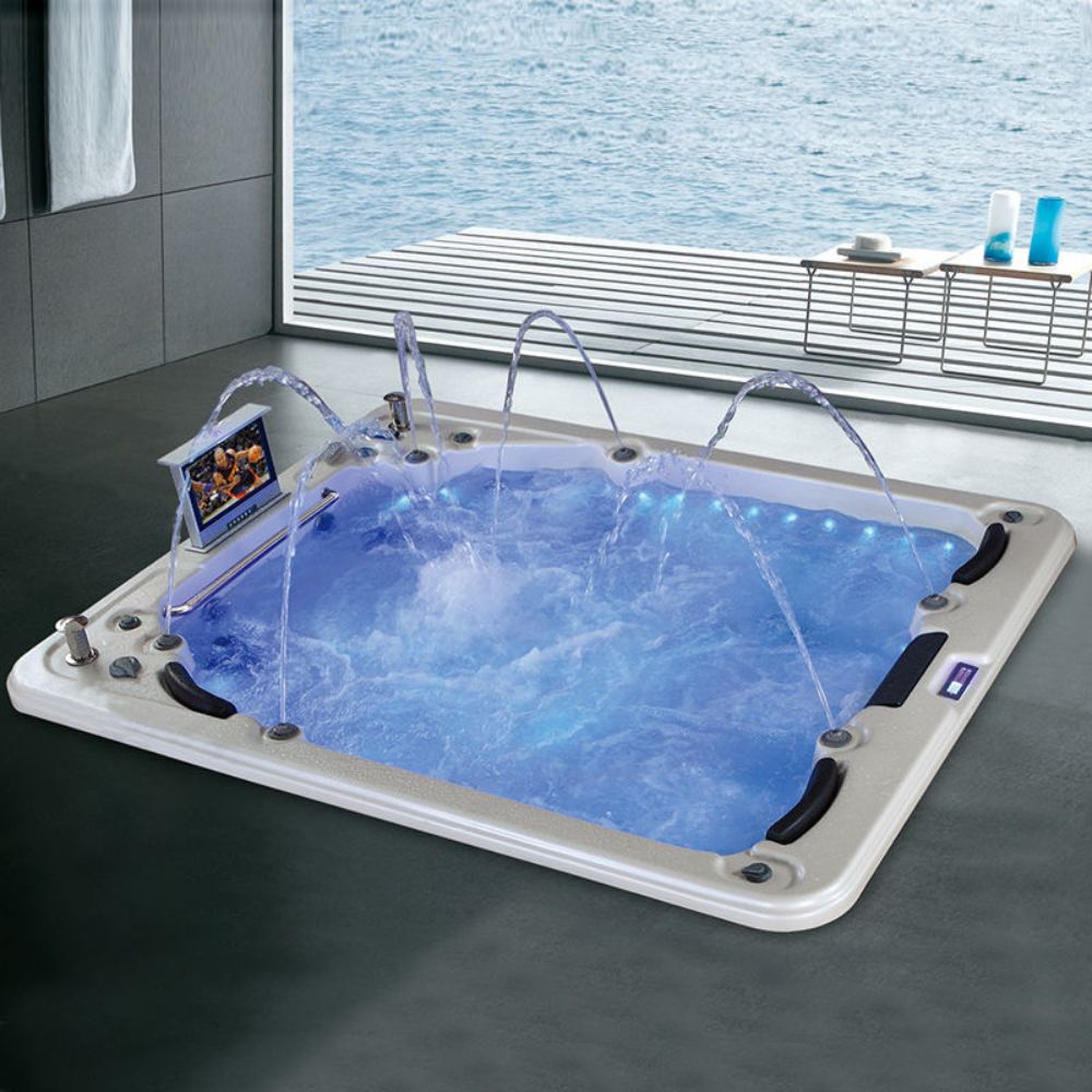 Portable hot tub with water features in a room setting