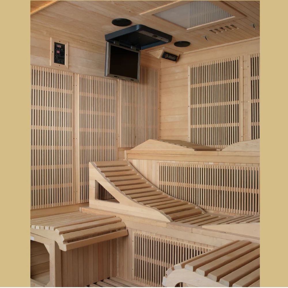 Wooden sauna with benches and a television mounted on the wall.
