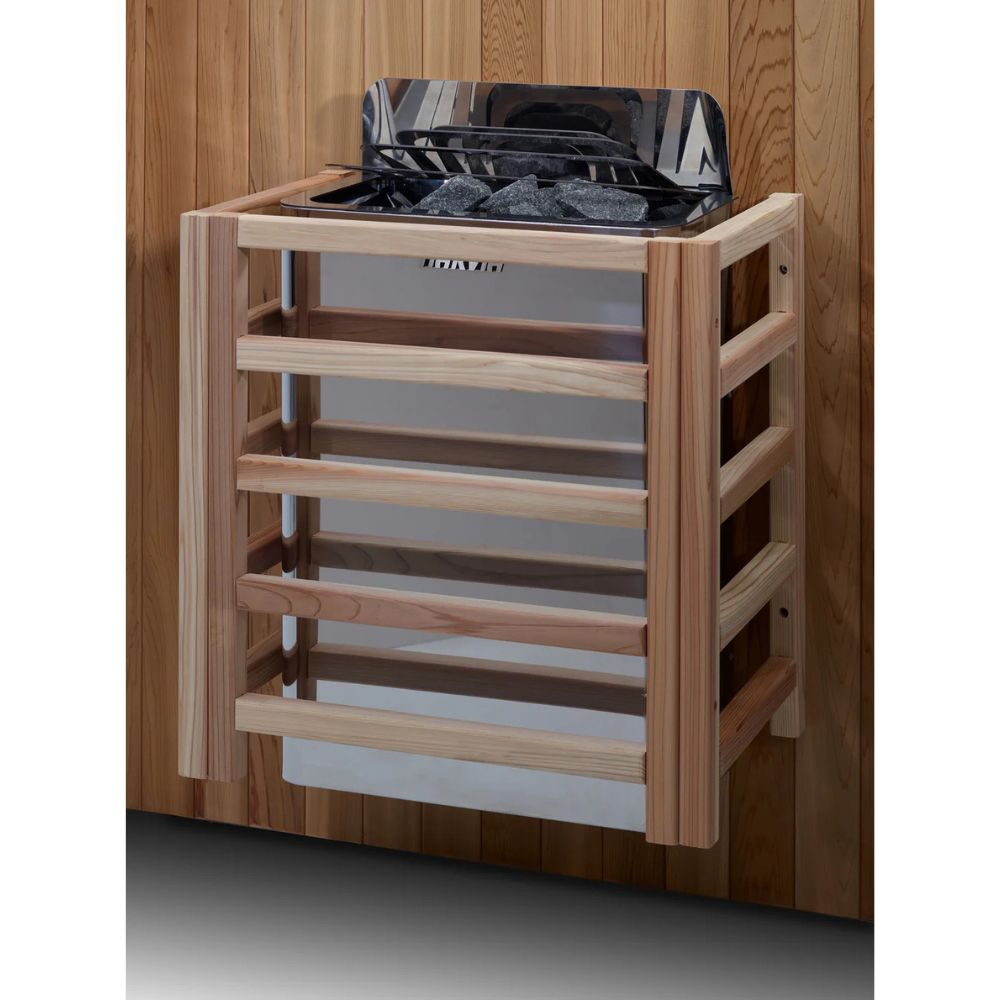 Wooden sauna shelf with rocks and a black container against a wooden wall.