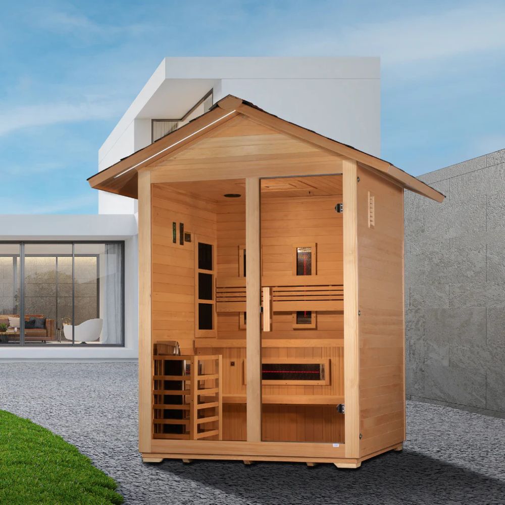 Wooden sauna outside a modern house with a clear sky.