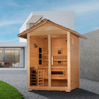 Wooden sauna outside a modern house with a clear sky.