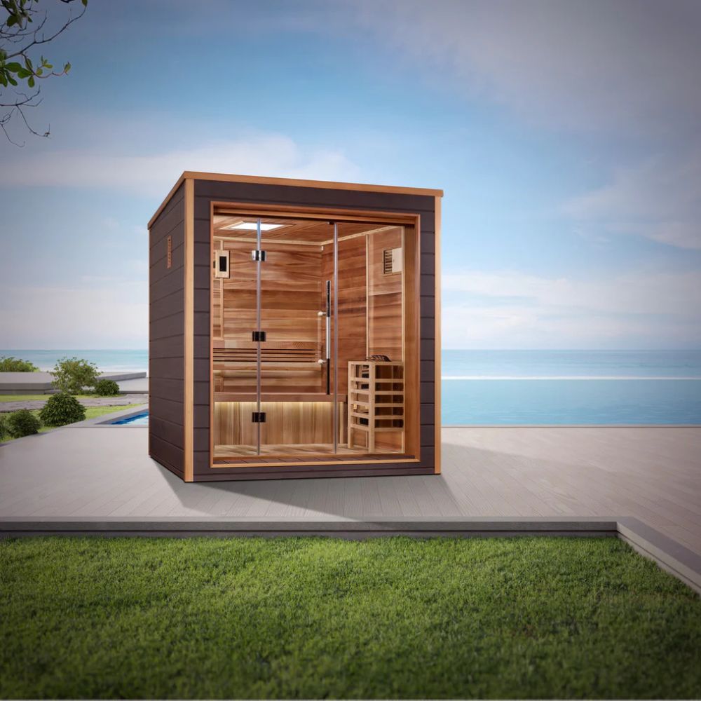 Wooden sauna with glass door on a patio with grass and blue sky background