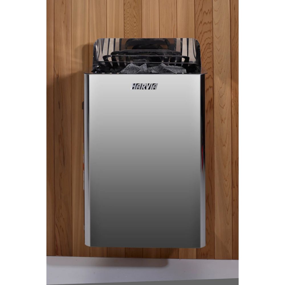 Stainless steel trash can with black liner against a wooden wall