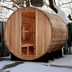 Wooden barrel-shaped sauna in a snowy outdoor setting