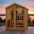 Wooden sauna on a deck with a scenic view of water and trees at sunset.