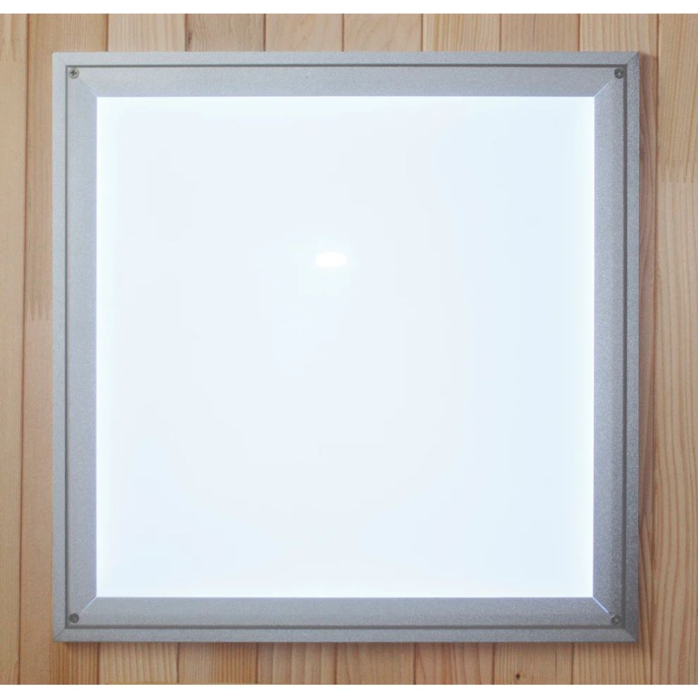 Square light fixture with silver frame on a wooden background