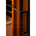 Close-up of a glass door with black handle on a white background