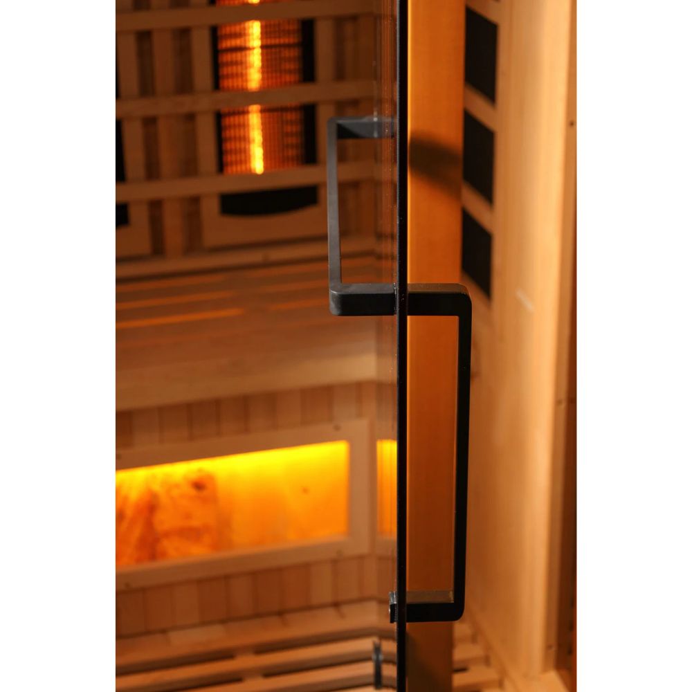 Infrared sauna with glowing interior and wooden design.