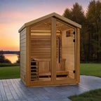 Wooden outdoor sauna with a scenic background of trees and water at sunset.