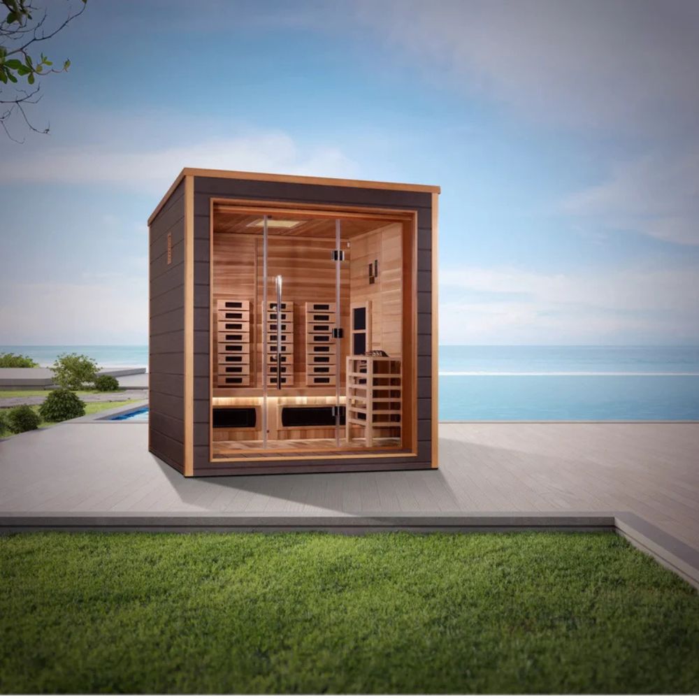 Wooden sauna cabin on a patio with a scenic background