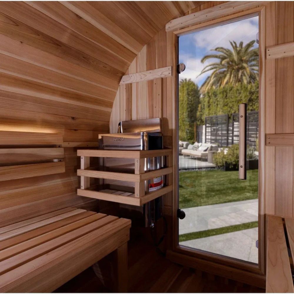 Wooden sauna with a view of a garden and pool area outside