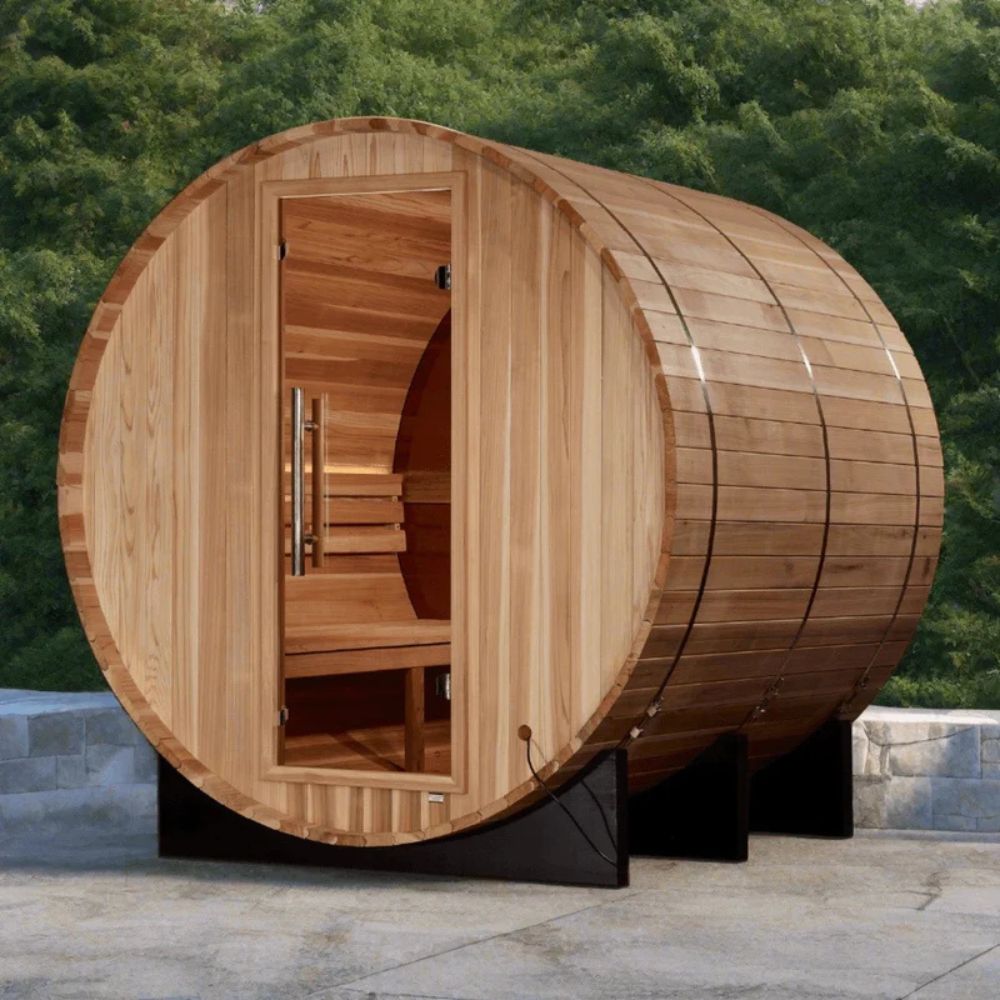 Wooden barrel-shaped sauna in a natural setting with trees in the background