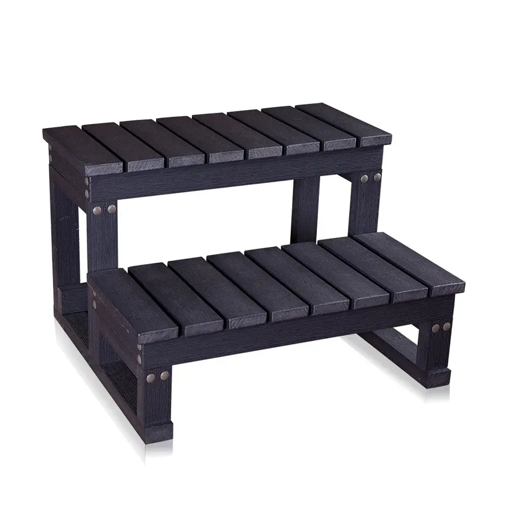 Black wooden step stool with two levels on a white background
