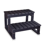 Black wooden step stool with two levels on a white background