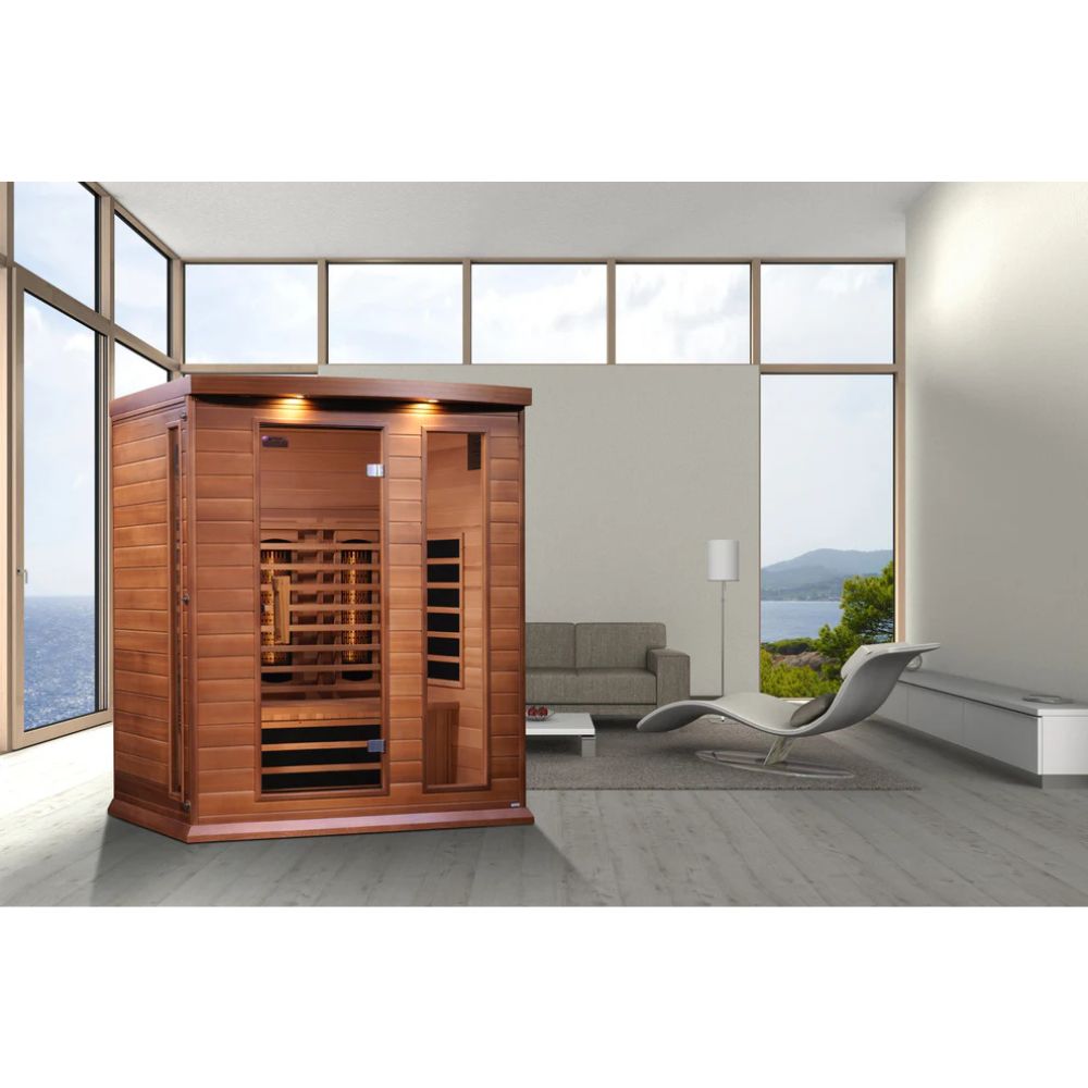 Wooden sauna in a modern room with large windows and a view of the ocean.