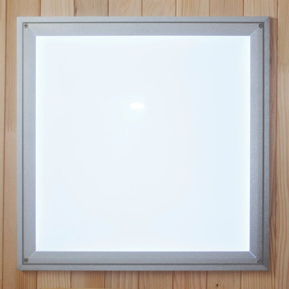 Square light fixture with metallic frame on a wooden background