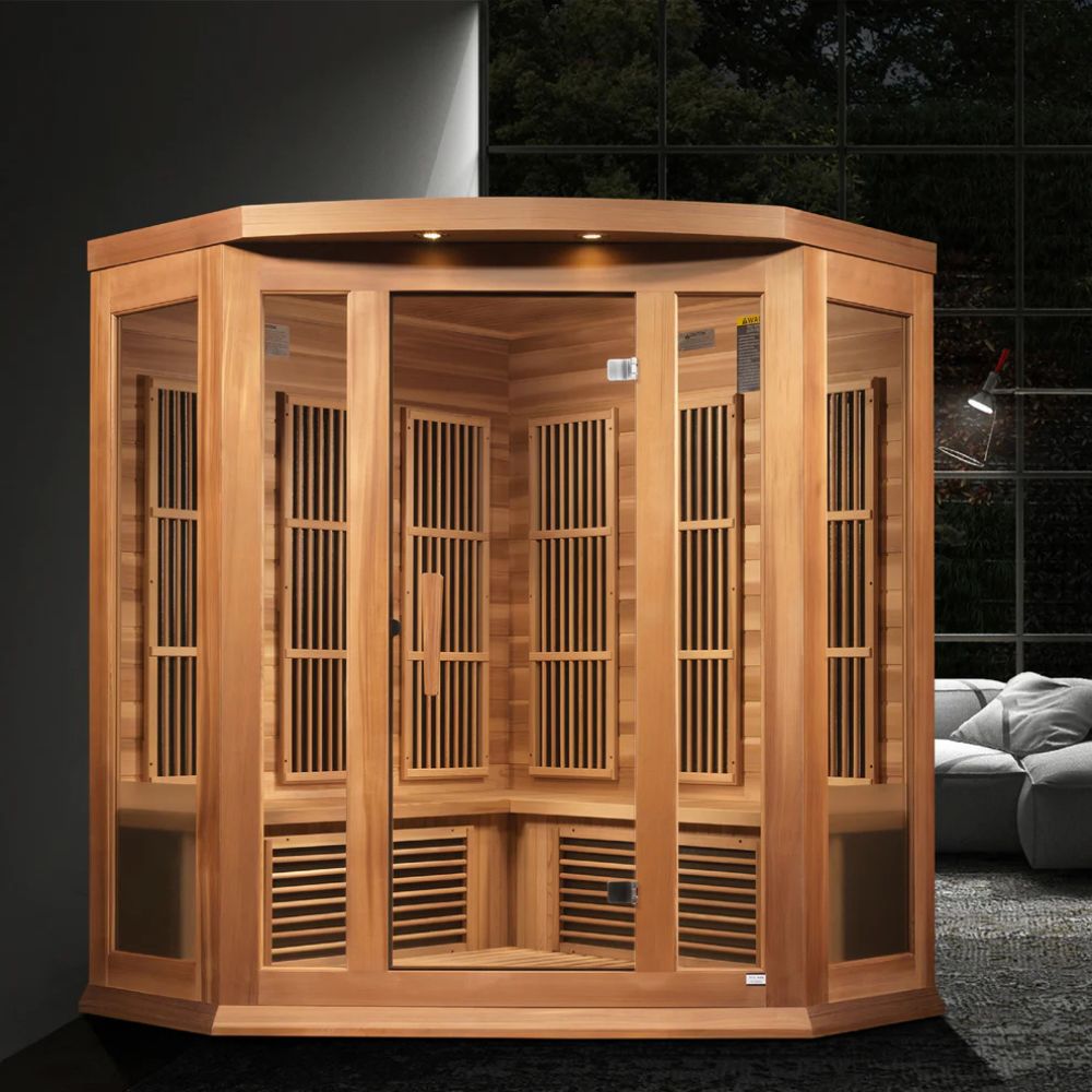 Wooden sauna cabin in a room with a dark tiled wall and gray sofa.