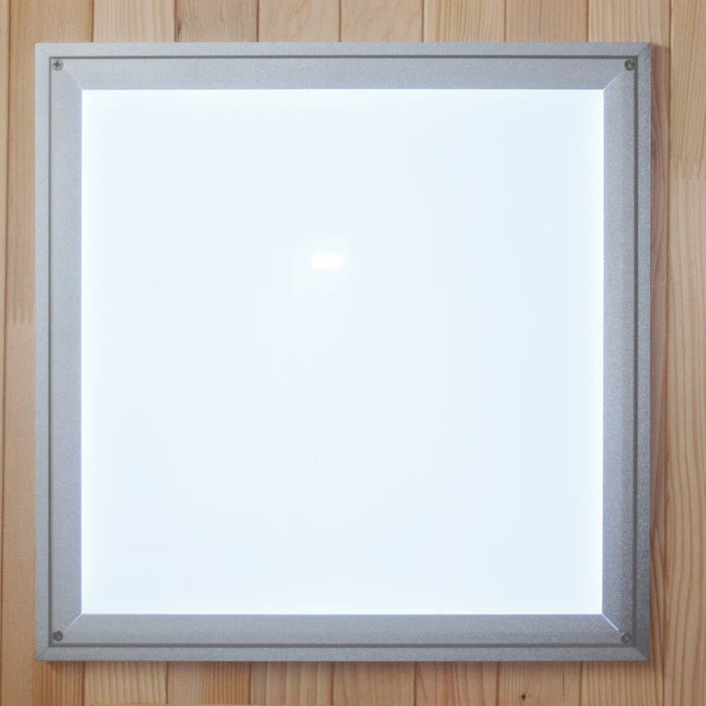Square light fixture with silver frame on a wooden background