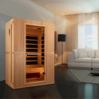 Wooden sauna in a modern living room with a white sofa and large window.