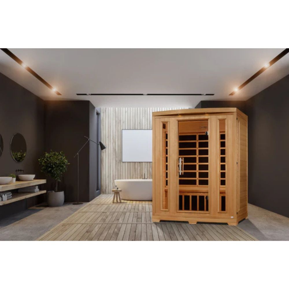 Wooden sauna in a modern room with dark walls and a bathtub.